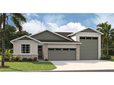 New home exterior with two-car garage and attractive landscaping at 9093 Players Dr, Weeki Wachee, FL 34613
