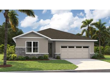 One-story home with gray siding, stone accents, and a two-car garage at 9109 Players Dr, Weeki Wachee, FL 34613