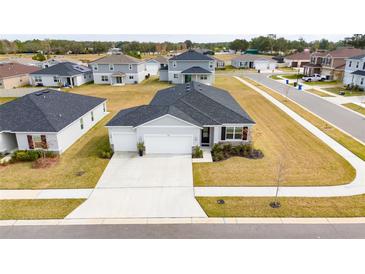 Aerial view of a house and surrounding neighborhood at 9415 Pinewood Point Pl, Seffner, FL 33584