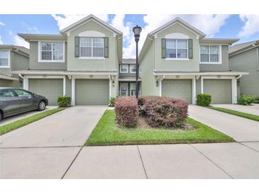 Two-story townhome with attached garage and landscaping at 2220 Kings Palace Dr, Riverview, FL 33578