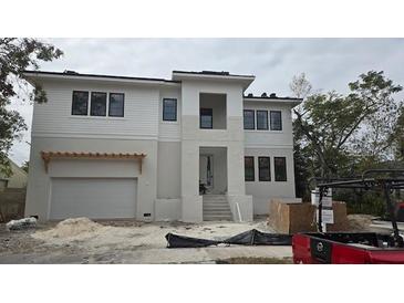 Two-story modern home with white siding, dark windows, and attached garage at 430 Columbia Dr, Tampa, FL 33606