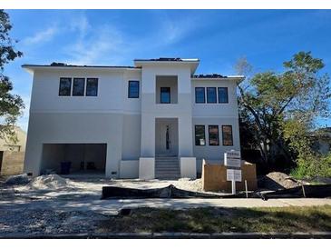 Two-story modern home with attached garage and landscaping at 430 Columbia Dr, Tampa, FL 33606