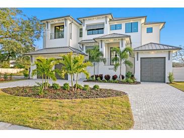 Stunning waterfront home with two-car garage and lush landscaping at 5032 W Longfellow Ave, Tampa, FL 33629