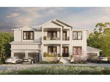 Two-story white farmhouse with a two-car garage and landscaping at 567 Luzon Ave, Tampa, FL 33606