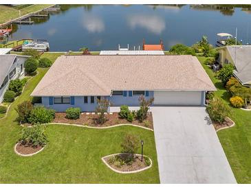 Single-story home with waterfront access and landscaped yard at 1707 Tahoe Dr, Sun City Center, FL 33573