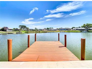 Private dock extending over calm water, offering waterfront access and scenic views at 1707 Tahoe Dr, Sun City Center, FL 33573