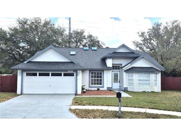 Charming single-story home featuring a two-car garage, well-kept lawn, and inviting front entrance at 4806 Mill Run Dr, New Port Richey, FL 34653