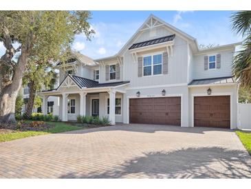 Beautiful two-story home featuring a brick driveway and a three car garage at 4010 W Watrous Ave, Tampa, FL 33629