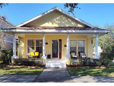 Charming yellow house with a front porch and well-manicured lawn at 3639 Hurston St, New Port Richey, FL 34655