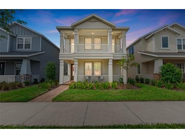 Charming two-story home boasting dual balconies, manicured lawn, and beautiful brick walkway at 13749 Rangeland Blvd, Odessa, FL 33556