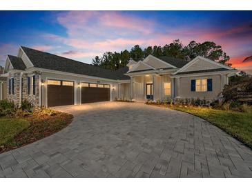 Elegant two-story home with three-car garage and paver driveway at 5018 Elm Leaf Dr, Brooksville, FL 34601