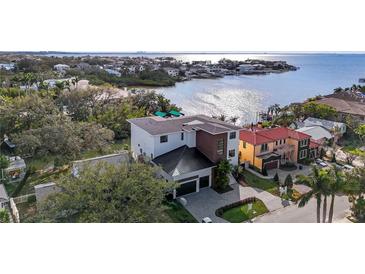 Beautiful aerial view of a modern two-story home on a waterfront property with bay access at 5006 W San Miguel St, Tampa, FL 33629