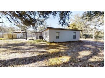 White single story home with covered carport and gazebo in backyard at 17130 Pasco Acres Dr, Spring Hill, FL 34610