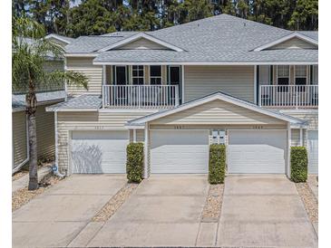 Tan three-unit building with attached garages and balconies at 1817 Hammocks Ave # 1817, Lutz, FL 33549