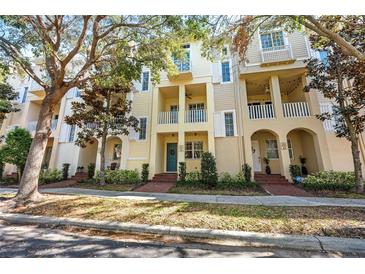 Charming yellow townhouses with private balconies and manicured landscaping offer inviting curb appeal at 6030 Printery St # 105, Tampa, FL 33616