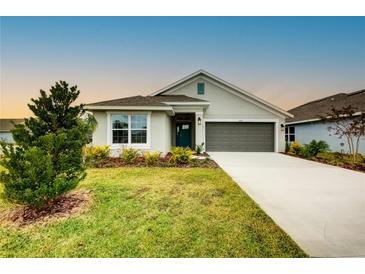 New single-story home with a two-car garage and landscaped front yard at 6907 162Nd E Pl, Parrish, FL 34219