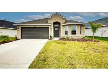 One-story home with attached garage and landscaped lawn at 6814 162Nd E Pl, Parrish, FL 34219