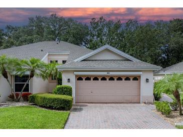 Two-story house with attached garage and landscaped yard at 604 Masterpiece Dr # 604, Sun City Center, FL 33573