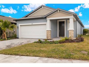 New construction home with two-car garage and attractive landscaping at 3782 Maxwell Park Dr, Sun City Center, FL 33573