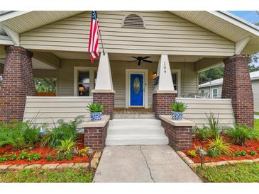 Charming craftsman home with a welcoming front porch and landscaped yard at 104 W Henry Ave, Tampa, FL 33604