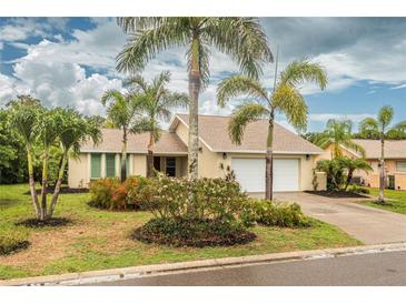Single-story home with a two-car garage and lush landscaping at 1501 63Rd W St, Bradenton, FL 34209