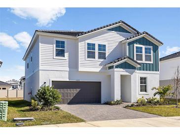 Beautiful two-story home with a two-car garage and a well-manicured lawn at 10288 Surrey Rose Dr, San Antonio, FL 33576