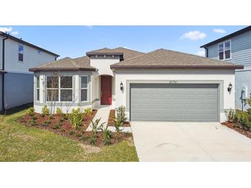 Beautiful one-story home with a well-manicured lawn, two-car garage, and neutral paint scheme at 20761 Balsam Hill Rd, Land O Lakes, FL 34638