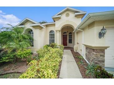 Inviting house exterior with landscaped front yard and walkway at 1704 Cresswell Manor Ct, Dover, FL 33527