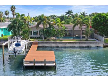 Aerial view of waterfront home with private dock and boat lift at 613 79Th S Cir, St Petersburg, FL 33707