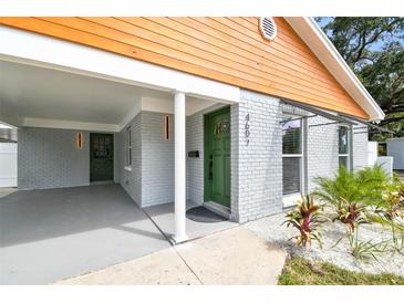 Green front door with a white frame and sidelights at 4607 W San Jose St, Tampa, FL 33629