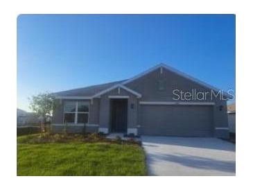 Charming single-story home with a well-manicured lawn and attached two-car garage at 11207 40Th E Ave, Palmetto, FL 34221