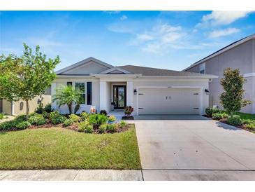 Beautiful two-story house with a two-car garage and well-manicured lawn at 5607 Limelight Dr, Apollo Beach, FL 33572