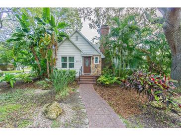 Charming bungalow with lush landscaping and brick pathway at 2367 Woodlawn W Cir, St Petersburg, FL 33704