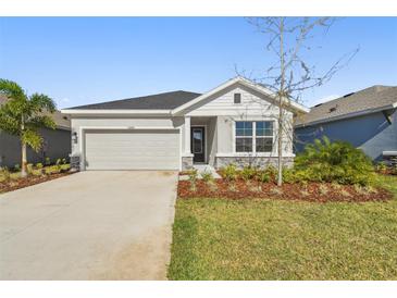One-story home with gray siding, stone accents, and a two-car garage at 11814 Richmond Trl, Parrish, FL 34219