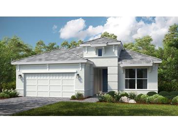 One-story home with gray roof, white walls, and a two-car garage at 4504 Isonzo Way, Wesley Chapel, FL 33543