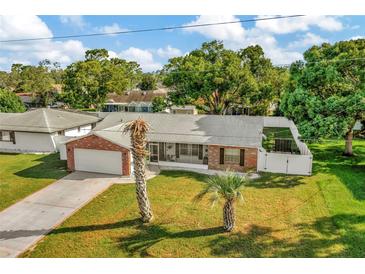 Charming single-story brick home with a well-manicured lawn and a two car garage at 13084 Drysdale St, Spring Hill, FL 34609