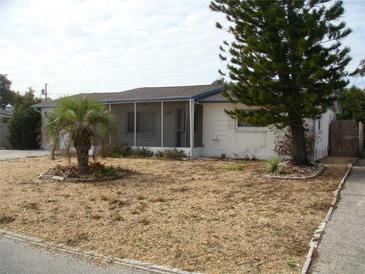 Cute bungalow with a spacious front yard at 3247 Kimberly Oaks Dr, Holiday, FL 34691