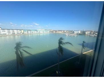 A waterfront view of a harbor with palm trees from inside this condo at 6025 Shore S Blvd # 412, Gulfport, FL 33707