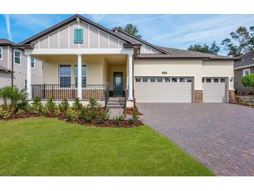 Two-story house with two car garage, front porch, and landscaped lawn at 4638 Southern Valley Loop, Brooksville, FL 34601