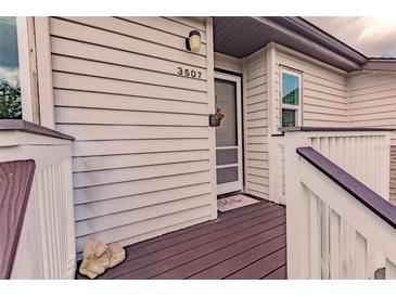 Inviting house entrance with a brown doormat, storm door, and small deck at 3507 59Th W Ave # 4020, Bradenton, FL 34210