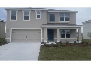 Two-story house with a two-car garage and landscaped yard at 6303 Distant Haze Pl, Palmetto, FL 34221