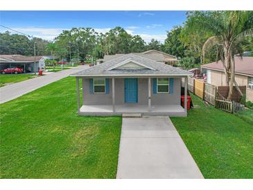 Newly renovated house with a blue door and a spacious lawn at 1311 E Church St, Plant City, FL 33563