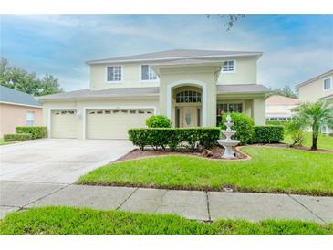 Two-story house with a three-car garage and manicured lawn at 4224 Fleewell Ct, Valrico, FL 33596