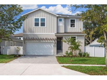 Charming two-story home with mature trees and a two-car garage at 3611 E Renellie Cir, Tampa, FL 33629