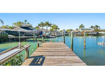 Wooden dock offers waterfront access, perfect for boating and fishing at 17710 Long Point Dr, Redington Shores, FL 33708