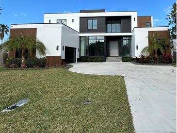 Modern two-story home with a large driveway and landscaped lawn at 1076 Snell Isle Ne Blvd, St Petersburg, FL 33704