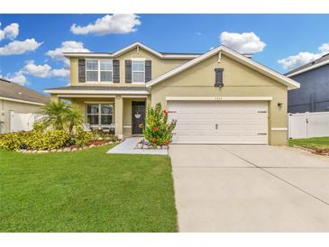 Charming two-story home with well-maintained lawn, landscaping, and a two car garage at 3314 San Moise Pl, Plant City, FL 33567