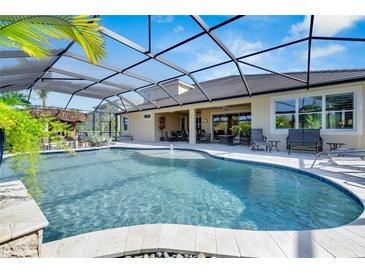 Inviting pool with covered patio, fountain, and ample seating at 824 Manns Harbor Dr, Apollo Beach, FL 33572