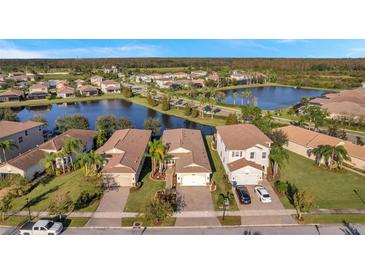 Aerial view of a beautiful community with lakefront homes at 2632 Tarragona Way, Wesley Chapel, FL 33543