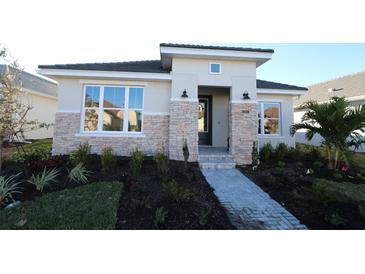 Single-story home with stone accents and landscaped walkway at 679 Allora Ave, Nokomis, FL 34275